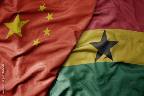 Photography big waving national colorful flag of china and national flag of ghana