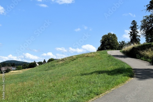 paved narrow road on a hillside near the city of winterthur switzerland