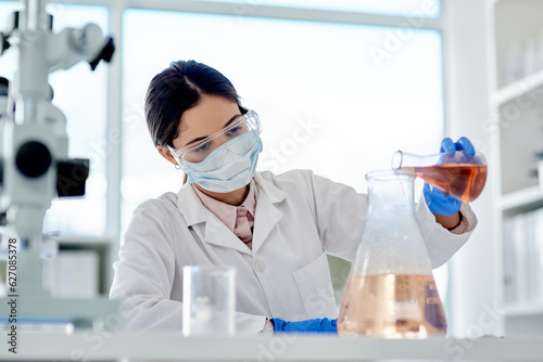 I hope this reacts as I expect it to. Shot of a young scientist doing an experiment in a lab.