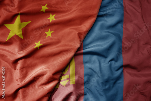 big waving national colorful flag of china and national flag of mongolia .