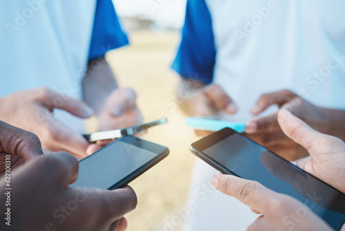 Hands, phone and networking with sports people in a huddle for communication or connectivity. Mobile, social media or information sharing with a person group standing in a circle closeup outdoors