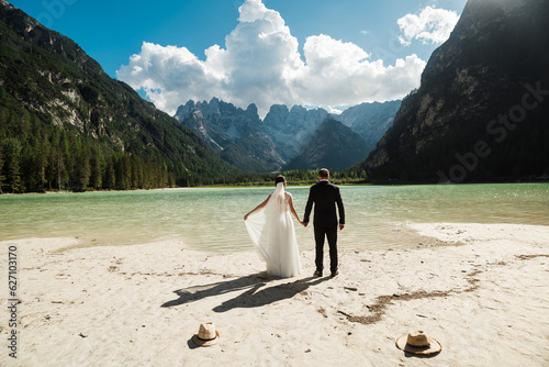 Beautiful married couple in their wedding dress at Lago di Landro  Italy