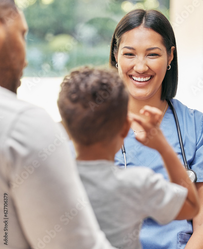 Father, child and nurse for health care in a hospital while happy and talking at consultation. African woman pediatrician, man and kid patient for medical help, family insurance or development check