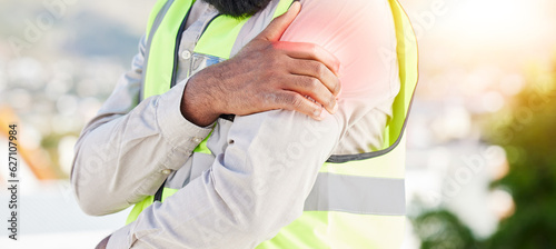 Man, architect and hands with shoulder pain in city from injury, accident or muscle tension on rooftop. Closeup of male person with sore arm, ache or joint inflammation during construction on site