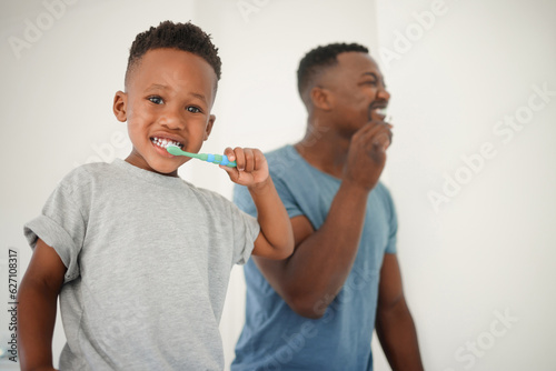 African father, bathroom and brushing teeth with son, care or love for cleaning, hygiene or dental health. Black man, boy and toothbrush in family house for portrait, smile or clean mouth in morning