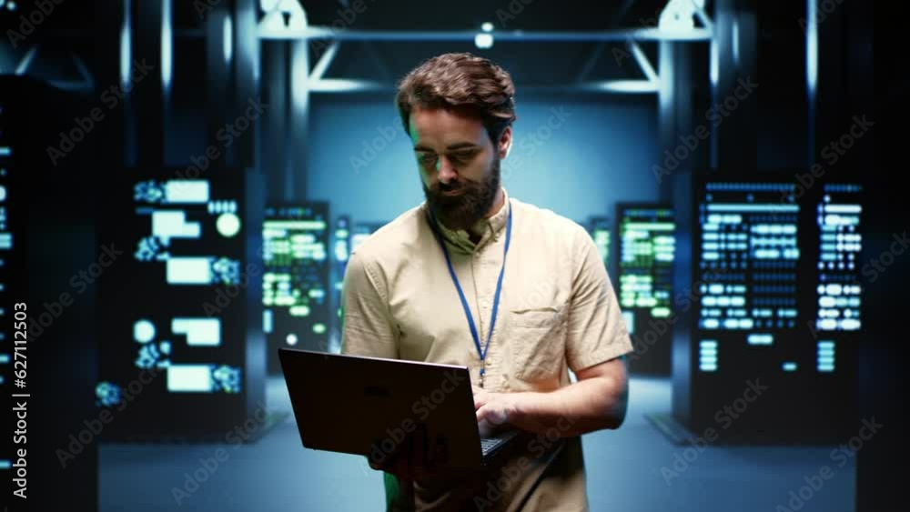 System administrator walking between operational server racks in computer network security data center, ensuring optimal performance. Engineer monitoring energy consumption across components System administrator walking between operational server racks in computer network security data center, ensuring optimal performance. Engineer monitoring energy consumption across components