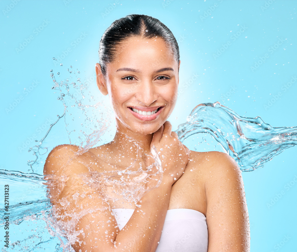 Water, skincare and shower with portrait of woman in studio for hygiene, beauty and splash. Wellness, cleaning and fresh with face of female model on blue background for spa, cosmetics and liquid