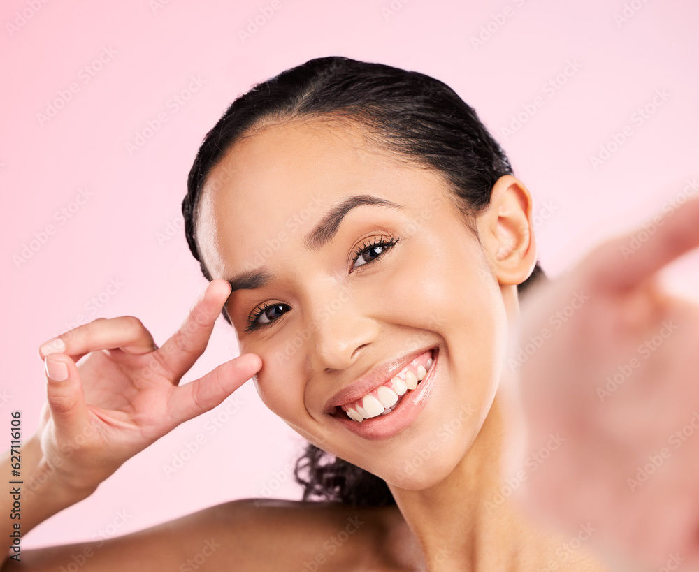 Selfie, peace hand sign and happy woman in studio with natural beauty, wellness and cosmetics. Portrait, female person and pink background with makeup and face with skincare and emoji gesture of girl