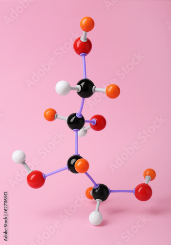 Molecule of sugar on pink background. Chemical model