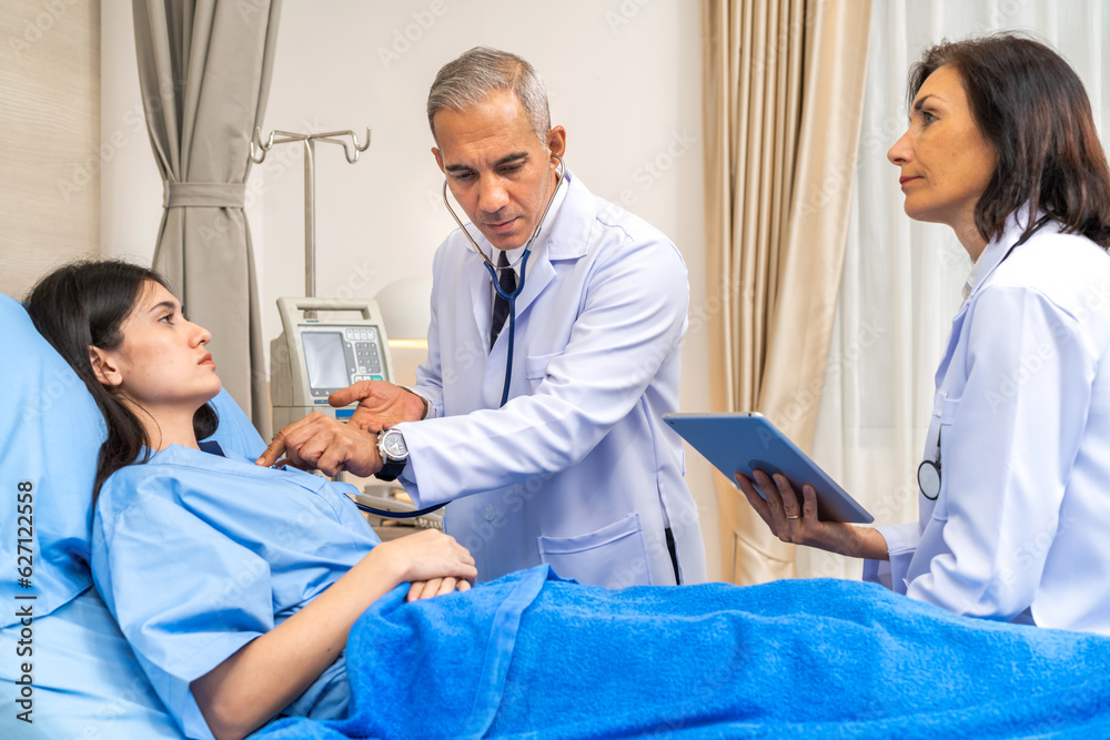 Fototapeta premium Senior man doctor wearing uniform with stethoscope help discussing and consulting talk to sick woman patient checkup information, support, care, diseases, treatment in hospital.healthcare