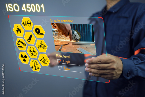 Engineering reading unsafe work reports through virtual screens and teaching subordinates in case study to be aware of wearing personal protective equipment or PPE at work. ISO 45001 safety first photo