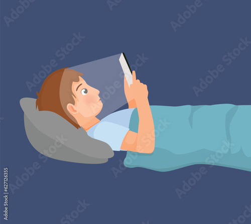 Young man using smartphone in the dark room lying on the bed