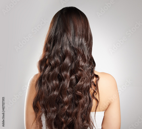 Hair, beauty with balayage and woman has curly hairstyle with haircare, keratin treatment and back view. Female person with color shine, texture with growth and grooming isolated on studio background
