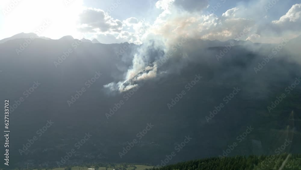 Forest fire in Switzerland. Large mountain is in flames. Smoke in the forest. Wildfire