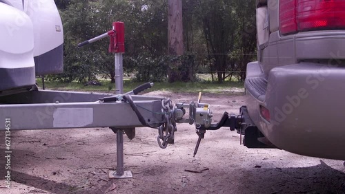 Reversing a car into a caravan or RV trailer hitch then lowering the jockey wheel.