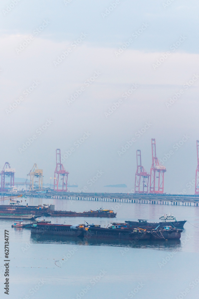 Engineering shipping crane depot at logistic export terminal control. Warehouse freight background container yard loading quayside harbor port. Logistics seascape shipping portal concept Engineering shipping crane depot at logistic export terminal control. Warehouse freight background container yard loading quayside harbor port. Logistics seascape shipping portal concept