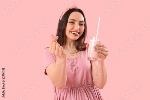 Smiling young woman holding...