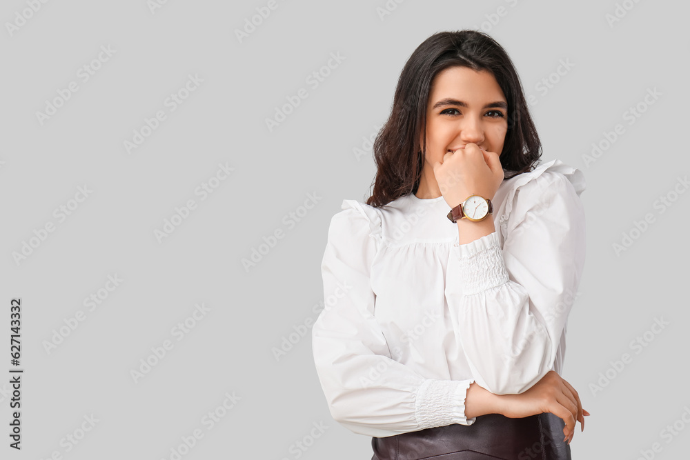 Beautiful young woman with wristwatch on grey background Beautiful young woman with wristwatch on grey background