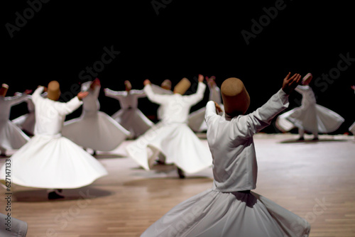 Dervishes perform on the stage for Mevlana photo