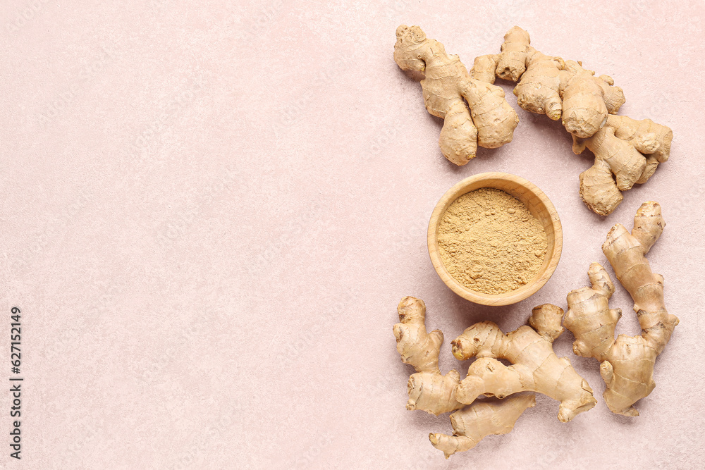 Fototapeta premium Fresh ginger roots and wooden bowl with dried powder on pink background