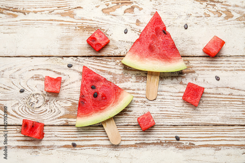 Composition with tasty watermelon sticks on light wooden background