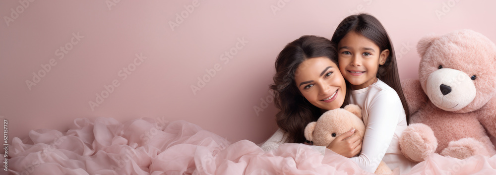 Portrait of a Indian girl and mother on pink rose gold background. World Mother's Day concept