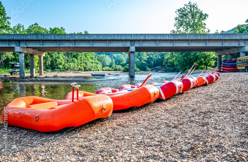 Row of inflatable rafts at the beginning of a float trip on a river.  photo
