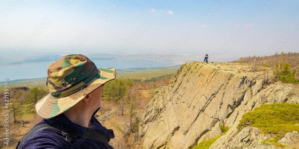portrait of a mature male tourist on top of a mountain range