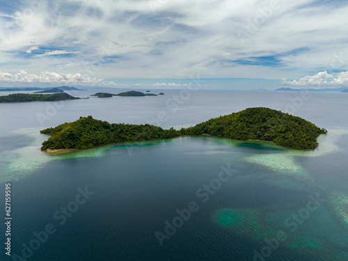 Aerial drone of islands with turquoise water and coral reef. Seascape in the tropics. Borneo, Sabah, Malaysia.