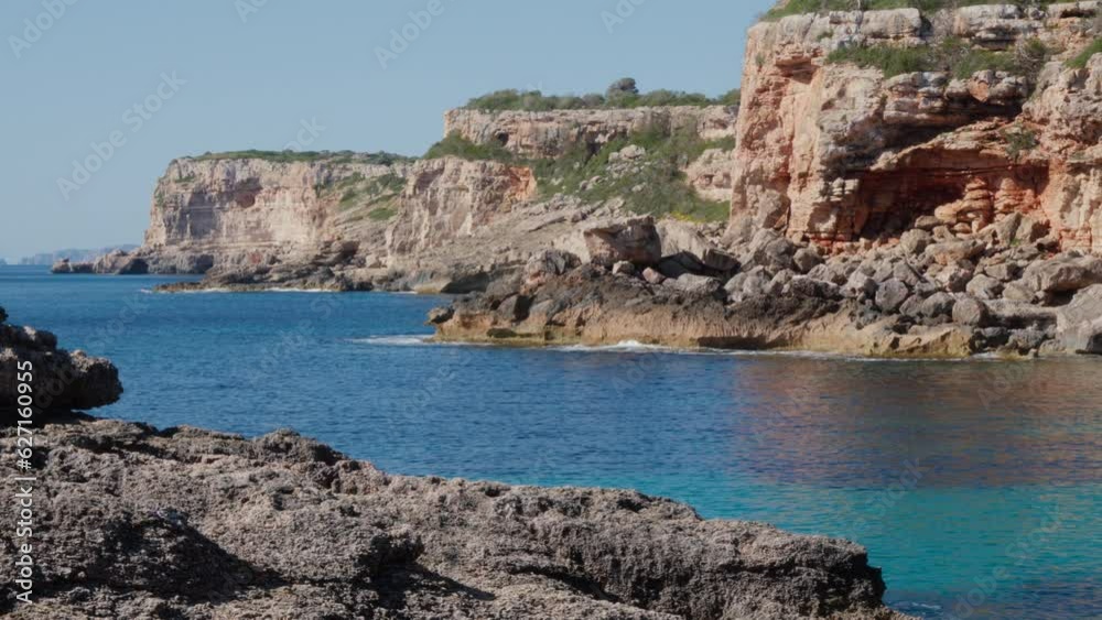 Turquoise waters of Mallorca, Spain, encircled by a rock formation. Turquoise waters of Mallorca, Spain, encircled by a rock formation.