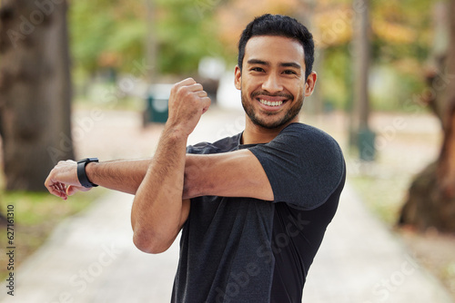 Happy asian man, portrait and stretching arms in fitness getting ready for running, workout or exercise at the park. Male person or runner with smile in warm up arm stretch, training or run in nature