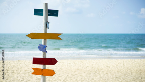 Empty Signs on beach.  Colorful wooden signs, the sea and white sand on background. 