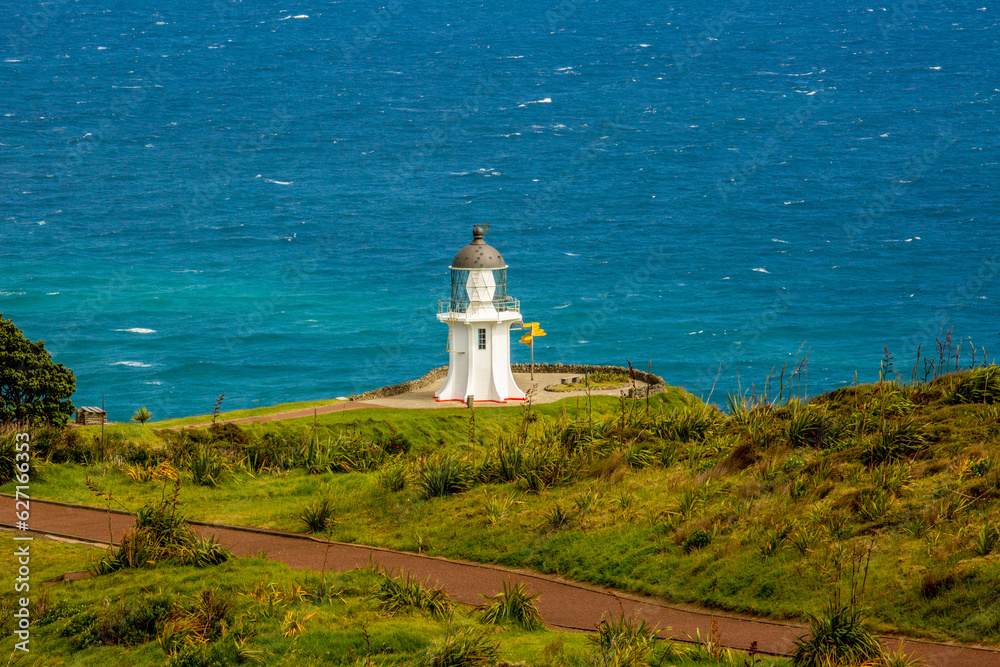 The spot where the Tasman sea and Pacific oceans meet at Cape Reinga and its historic lighthouse

