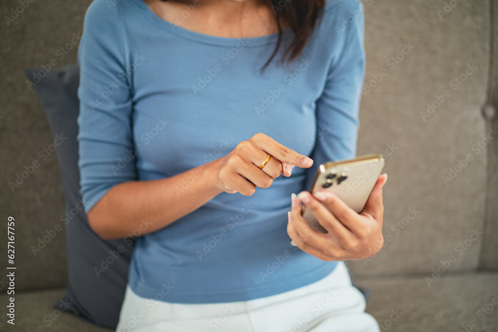 Asian Woman with Smartphone on sofa working mobile devices. cell telephone technology e-commerce concept. Relax at home Asian Woman with Smartphone on sofa working mobile devices. cell telephone technology e-commerce concept. Relax at home