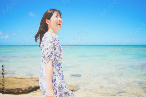 沖縄のビーチでバカンスを満喫するワンピースの女性