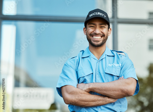 Happy man, portrait and security guard with arms crossed in city for career safety or outdoor protection. Male person, police or officer smile in confidence, law enforcement or patrol in urban town © Mumtaaz Dharsey/peopleimages.com