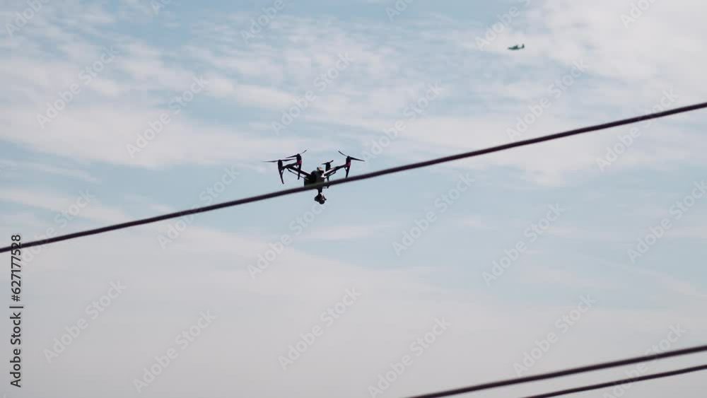Drone inspecting distribution pole, power pole Drone inspecting distribution pole, power pole