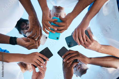 Fotografija Hands, phone and app with people in a huddle or circle for communication or connectivity