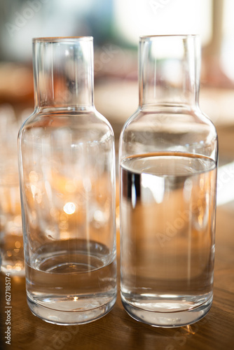 empty clean glass decanters for water in a restaurant on a bar counter