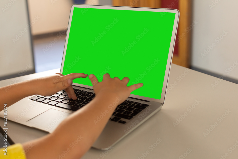 Mid section of a boy using laptop while having a video call on laptop with copy space at home Mid section of a boy using laptop while having a video call on laptop with copy space at home