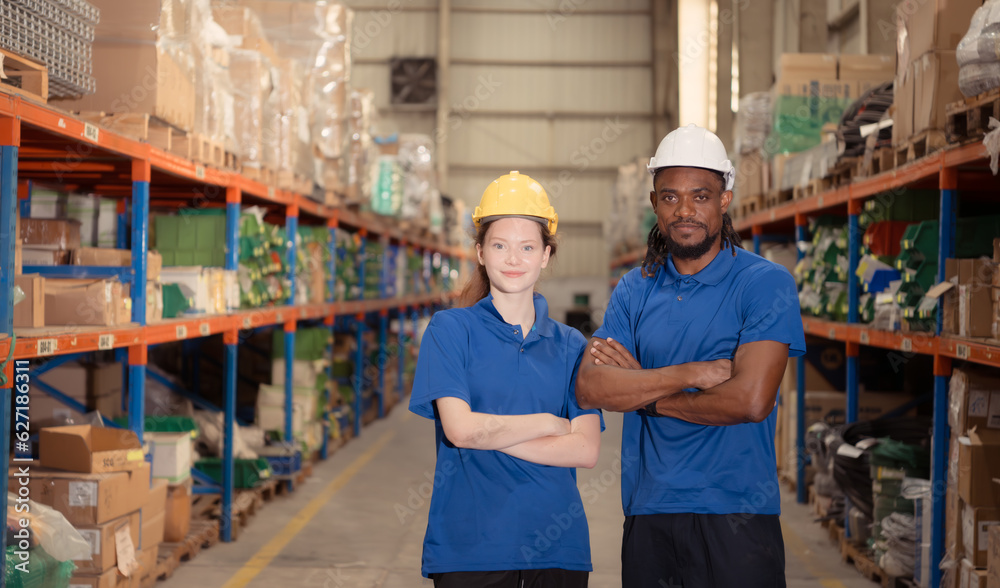 Portrait of confident warehouse staff standing with arms crossed in a warehouse Portrait of confident warehouse staff standing with arms crossed in a warehouse