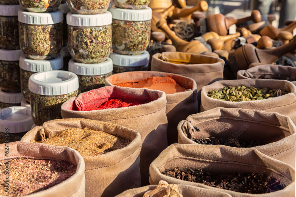 Fototapeta premium Bags of mixed spices and herbal tea in the street market. National cuisine and cooking concept. Bukhara, Uzbekistan