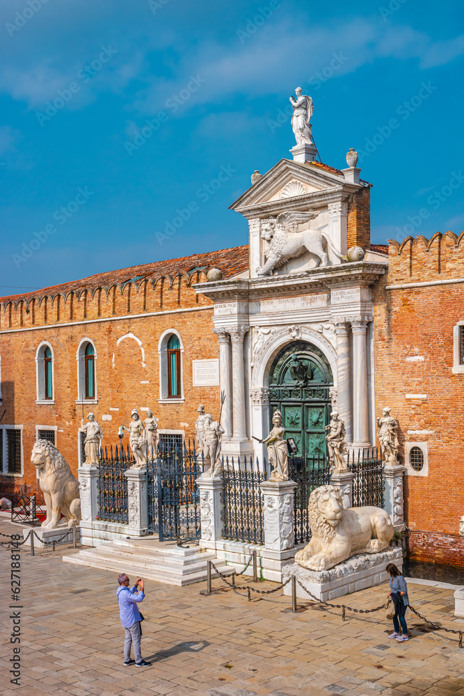 Venice, Italy - Famous Arsenal, military fortress, guard towers at gate and bridge in historical downtown of Venice, Italy. Blue deep sky and sunny day