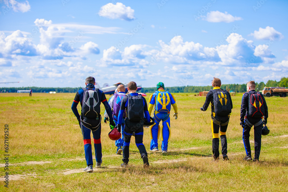 Skydivers-athletes are on the airfield, preparing to jump. Skydivers-athletes are on the airfield, preparing to jump.