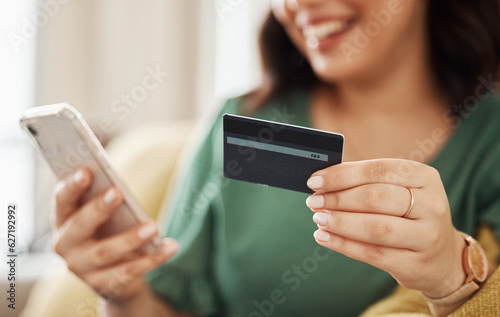 Phone, credit card closeup and woman hands with online shopping and banking at home. Ecommerce, mobile cashback and sale with digital payment and easy pay with discount and smile from web checkout