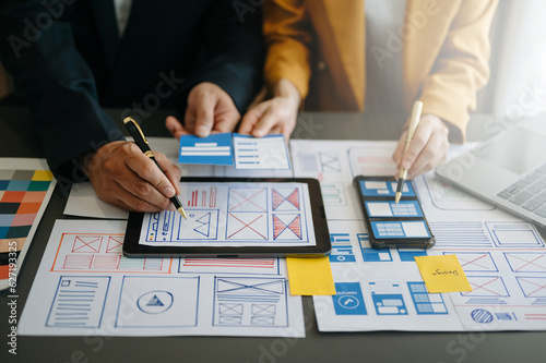 Obraz na płótnie UX graphic designer planning application process development prototype wireframe for web smart phone. Creative digital development agency..