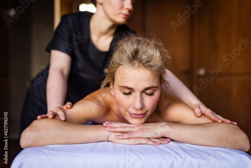 Beautiful adult woman enjoying relaxing day at the spa - Attractive adult female having a body care beauty treatment at wellness beauty centre