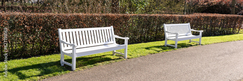 Fotografie Panoramic image. Empty white park benches in the park