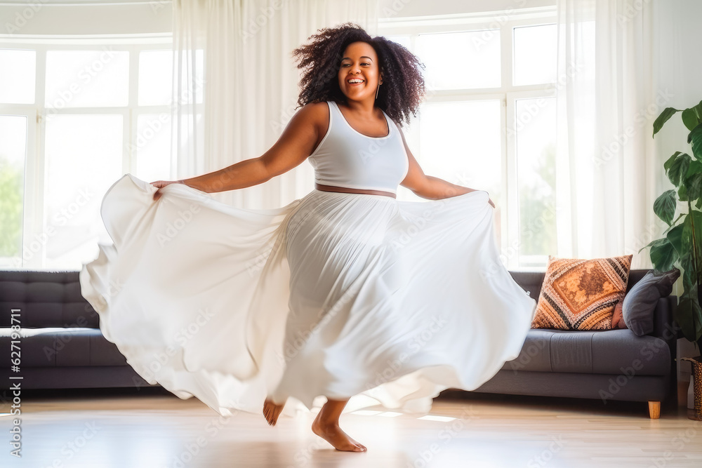 Positive plus size african woman dancing at home. Happiness and well being concept. Positive plus size african woman dancing at home. Happiness and well being concept.