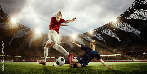 WOrld football cup. Two women, professional football players competing for the win, playing on 3D open air arena. Concept of professional sport, competition, dynamics, game, ad © master1305